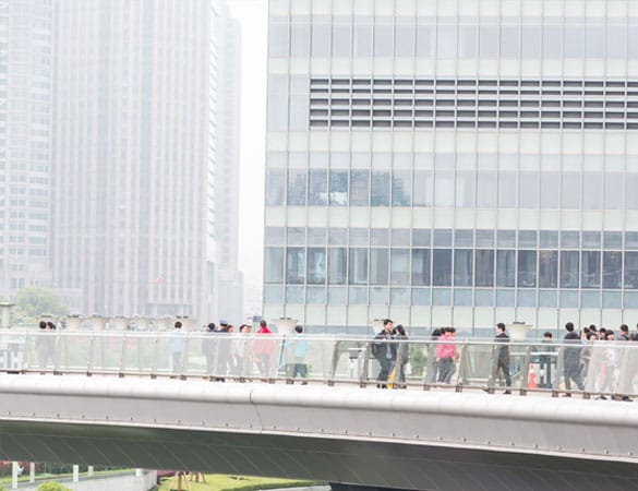 People walking across a foot bridge