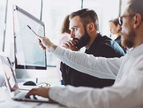 Two men looking at computer screen