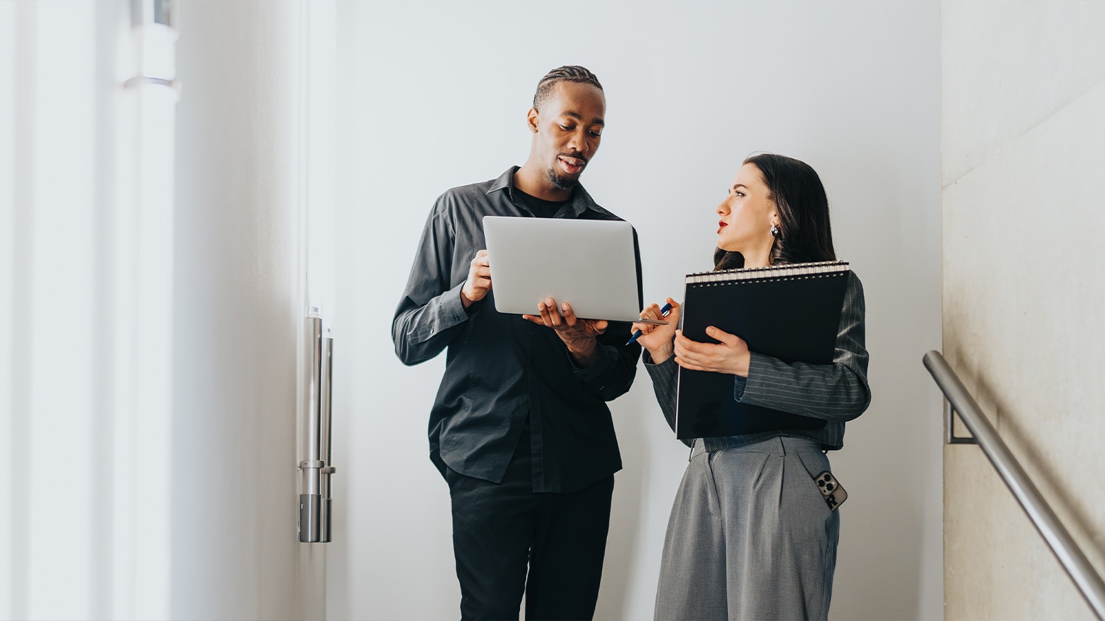 Image of two people talking.