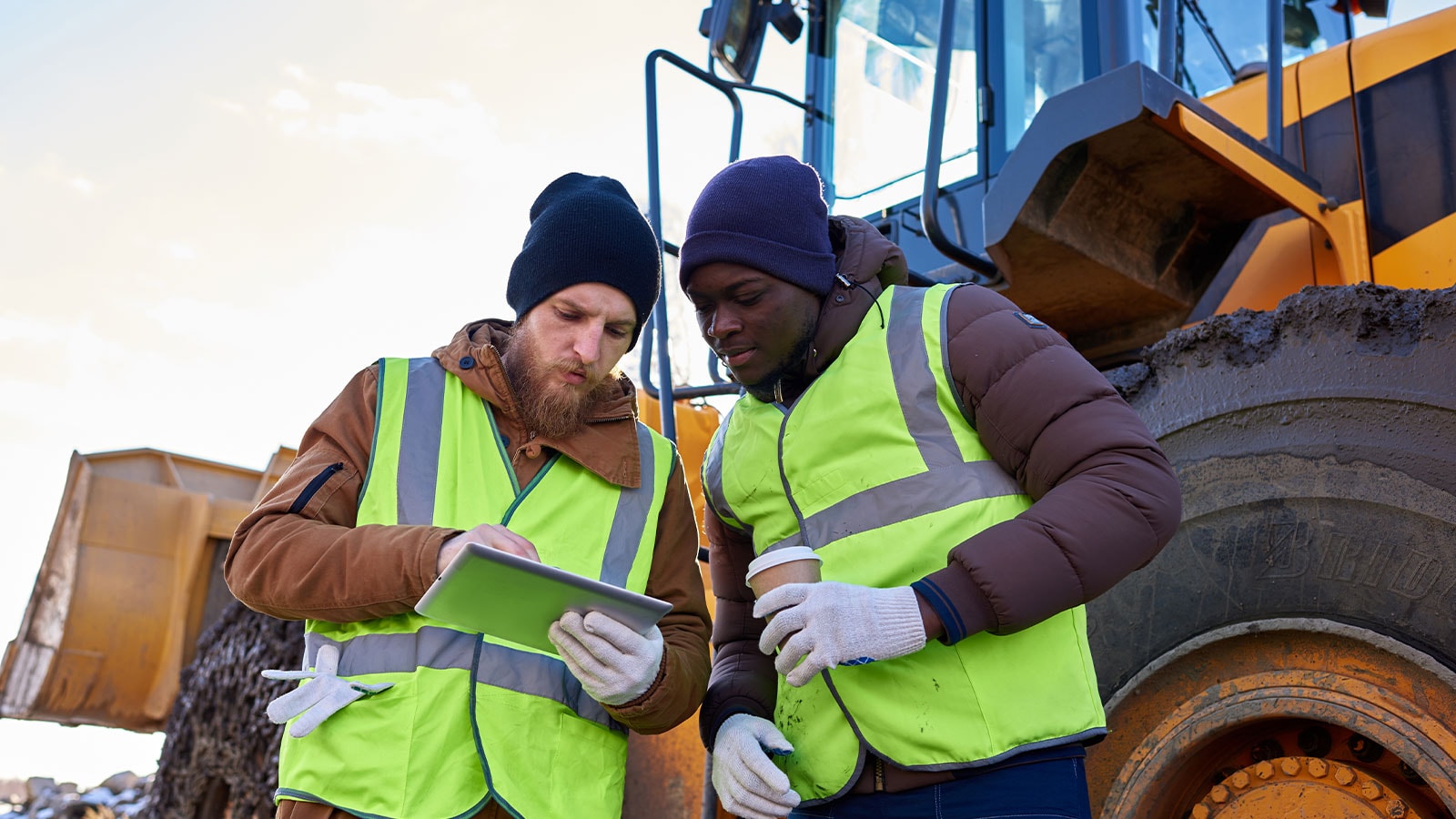 Two construction workers standing together.