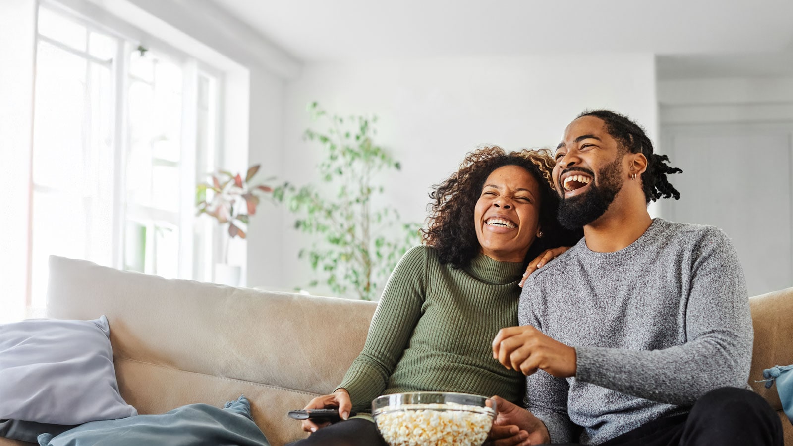 Image of tqo people watching television.