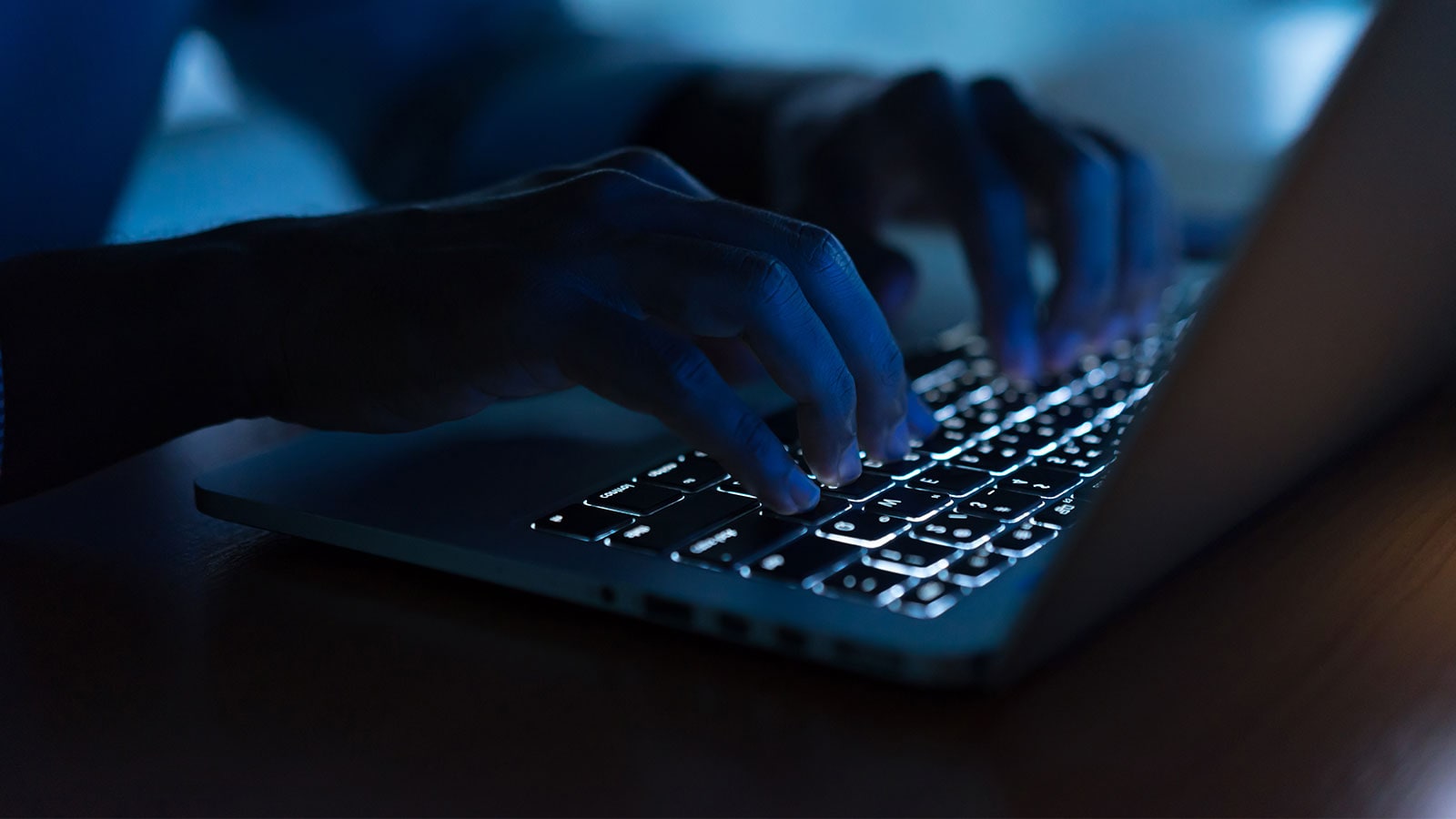 Hands typping on a keyboard.