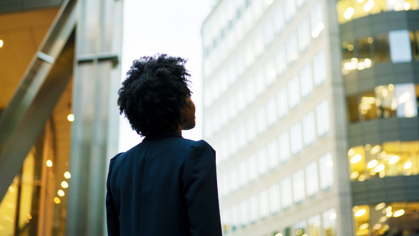 Woman looking up at a building.