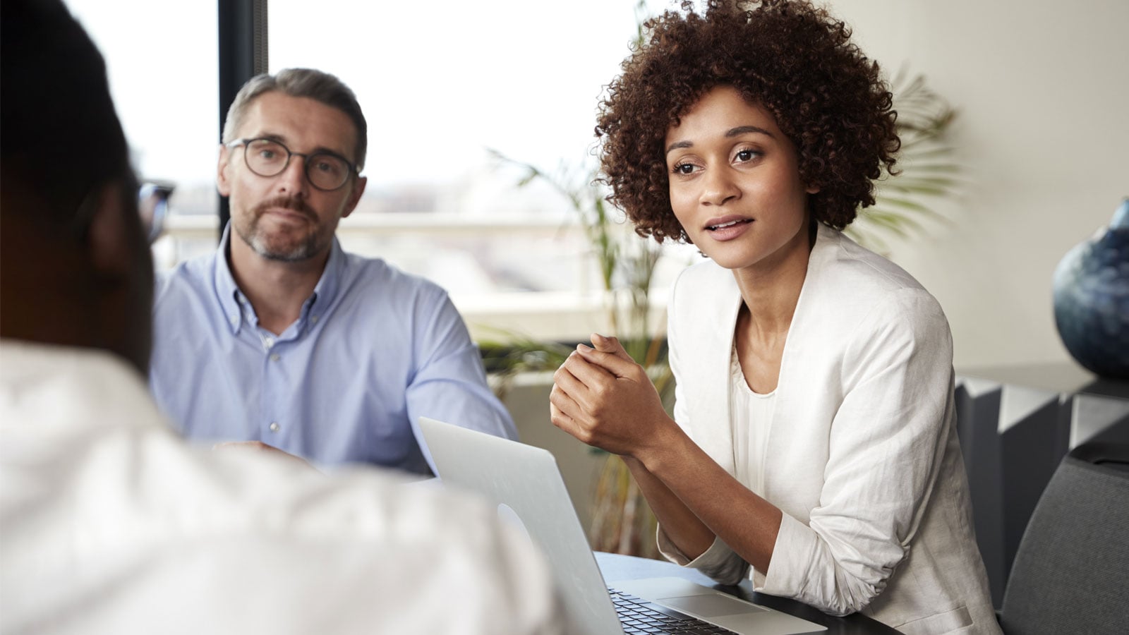 Woman sitting in a meeting.