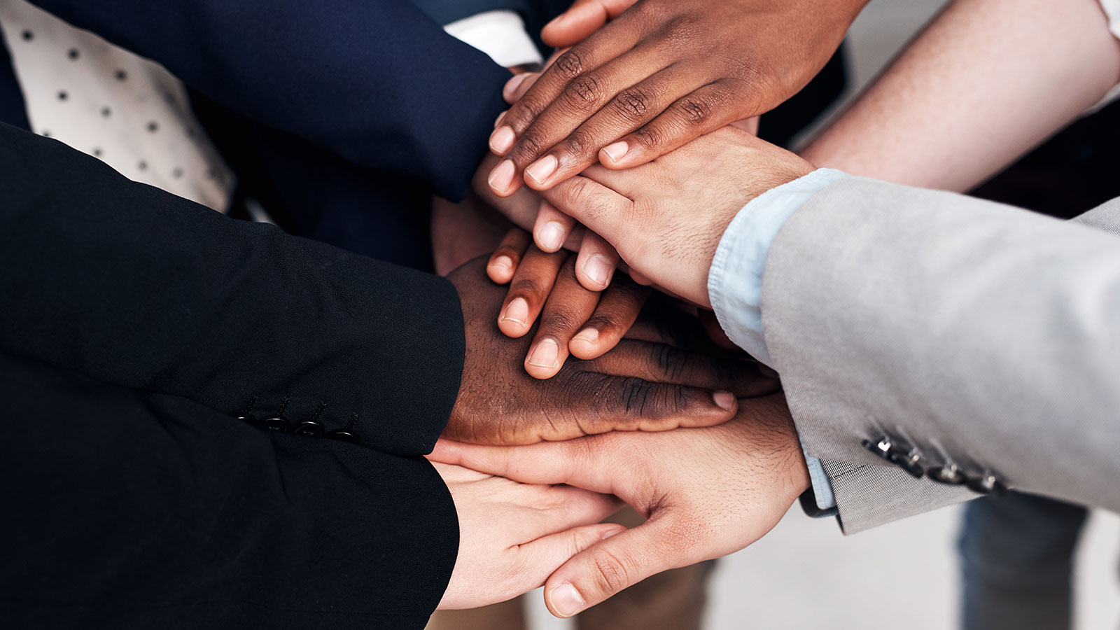 People with their hands together.