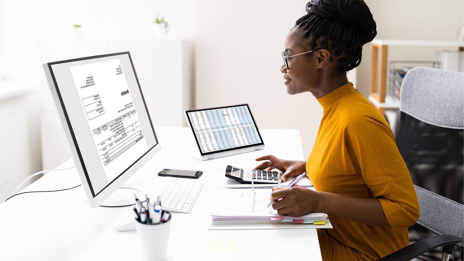 Woman looking at financial statements on her computer.
