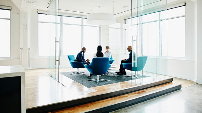 Group of people discussing actuarial services.