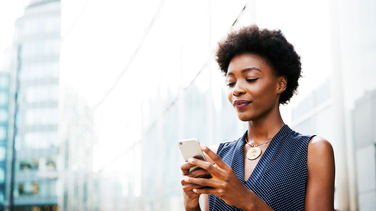 Woman searching for jobs at PwC on her cellphone.