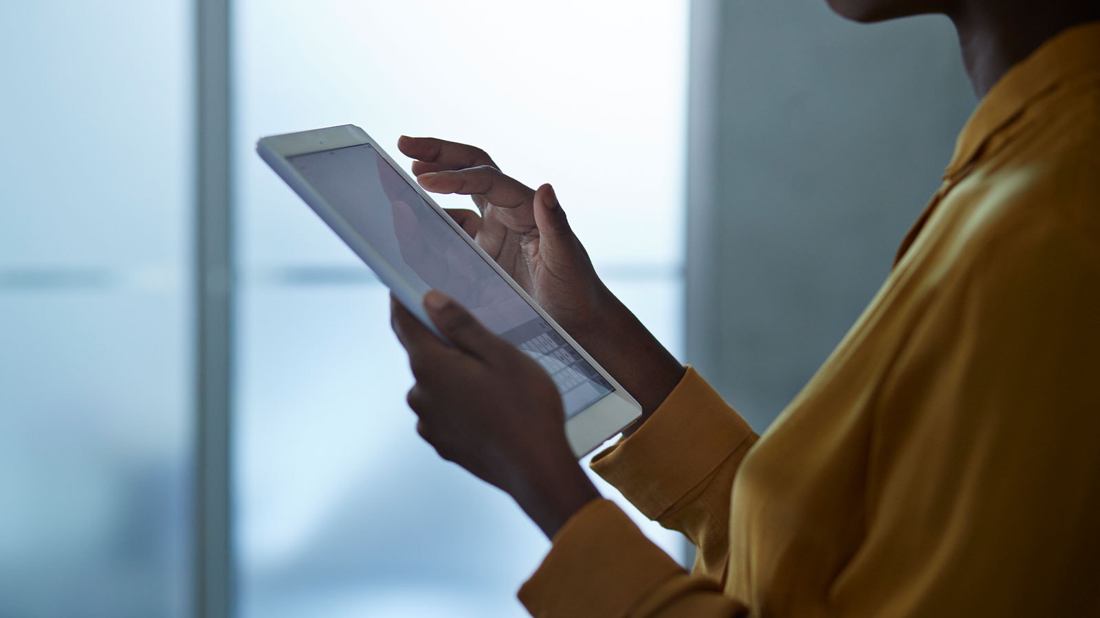 Woman working on a tablet.