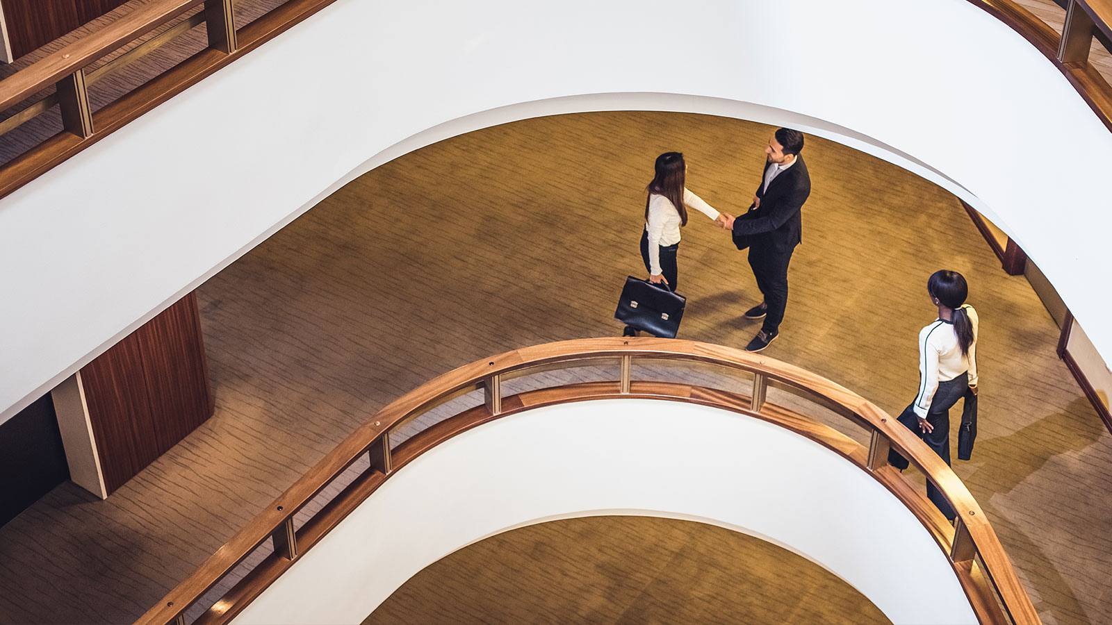 Two people standing in an office building.