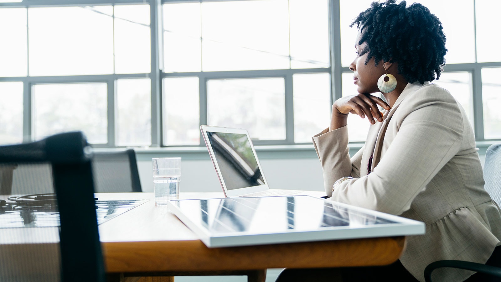 Woman thinking about the importance of proactiveness in debt management.