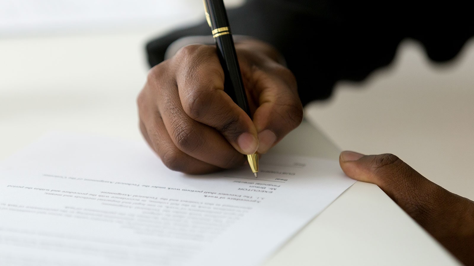 Man signing a financial debt statement.
