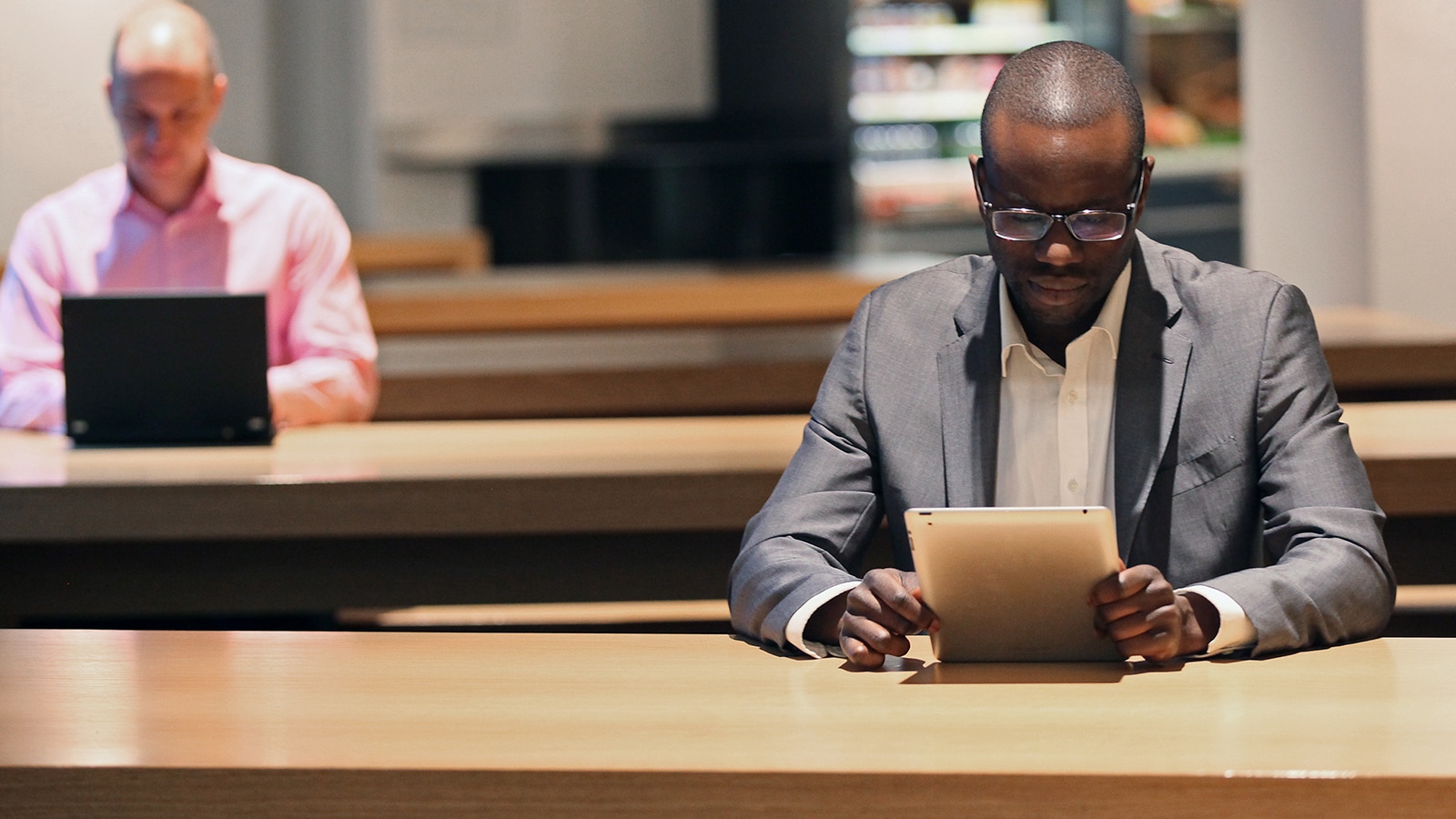 Male reading on tablet