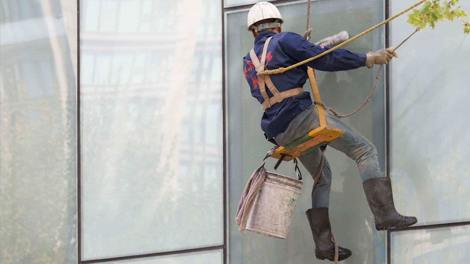 Image of a man cleaning windows.