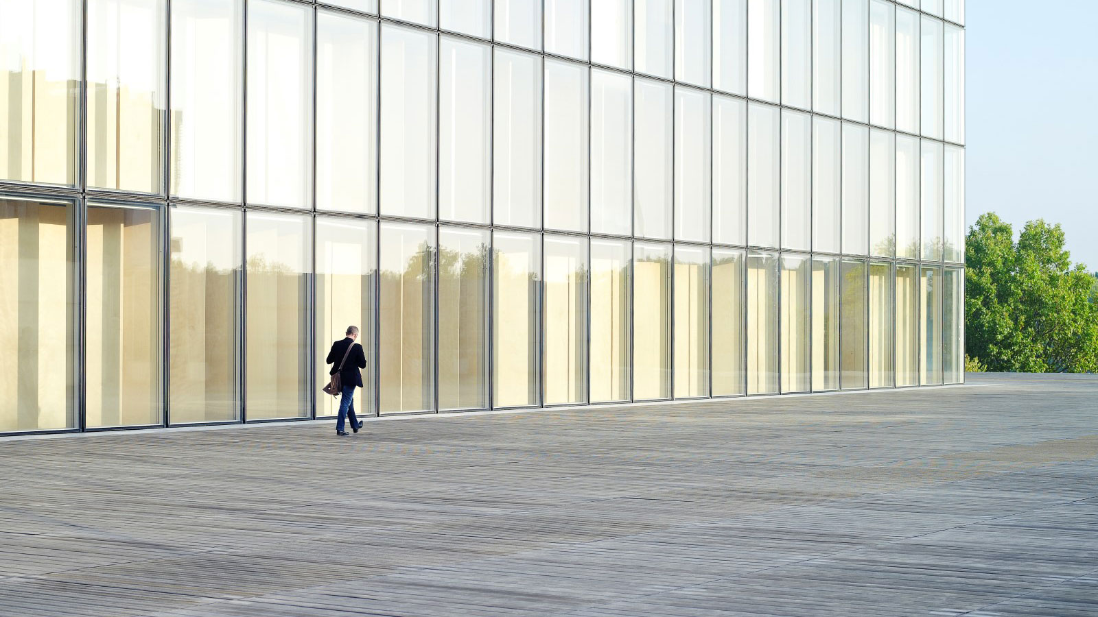 man-walking-near-glass-building