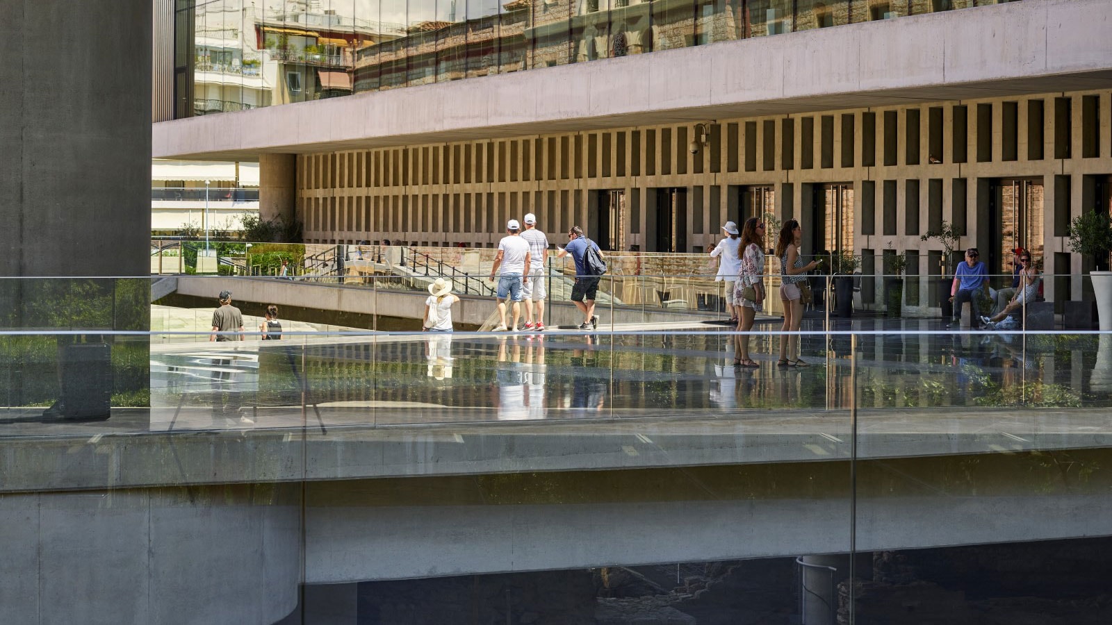 People standing on a glass bridge