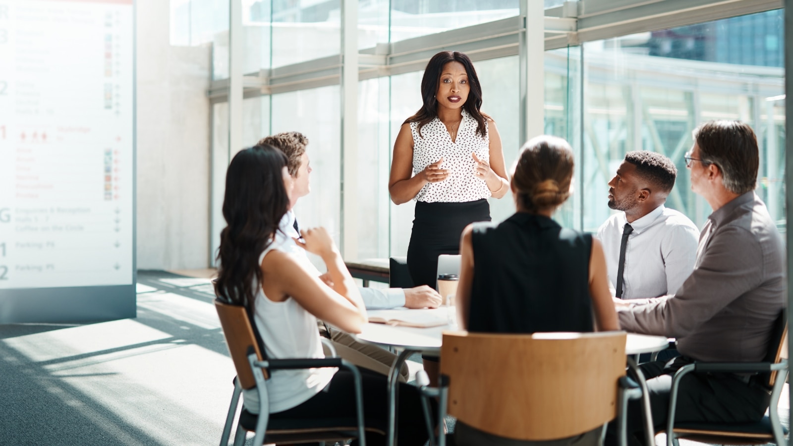 Group of people discussing insurance.