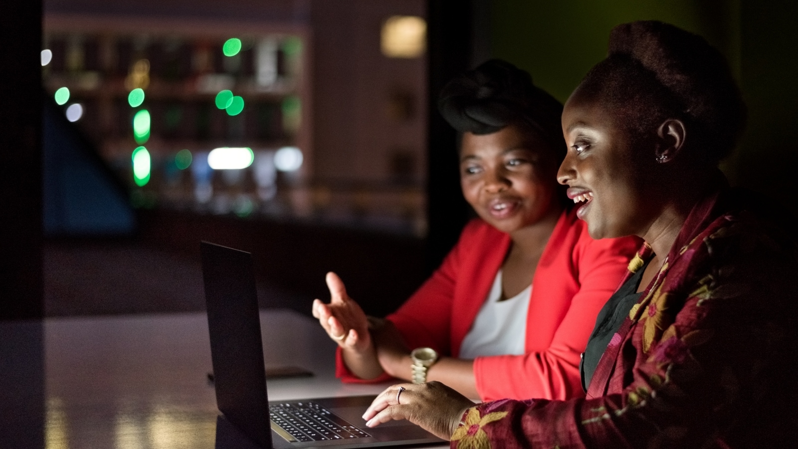 Two women looking at a computer.