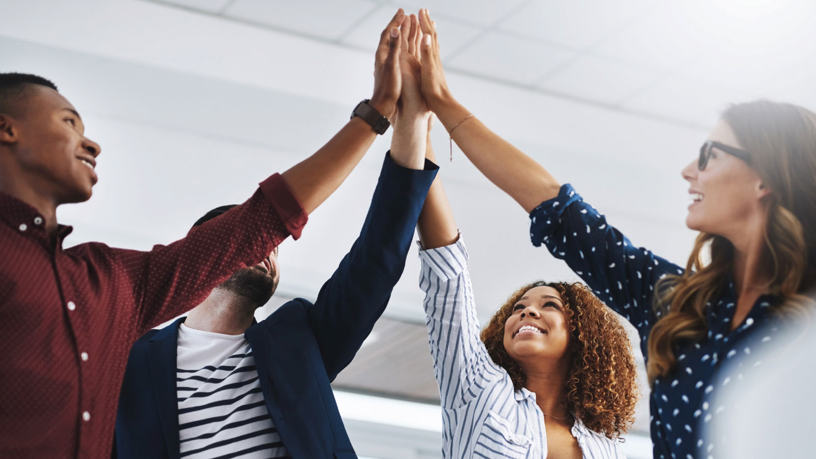 group of 5 people sharing a high five