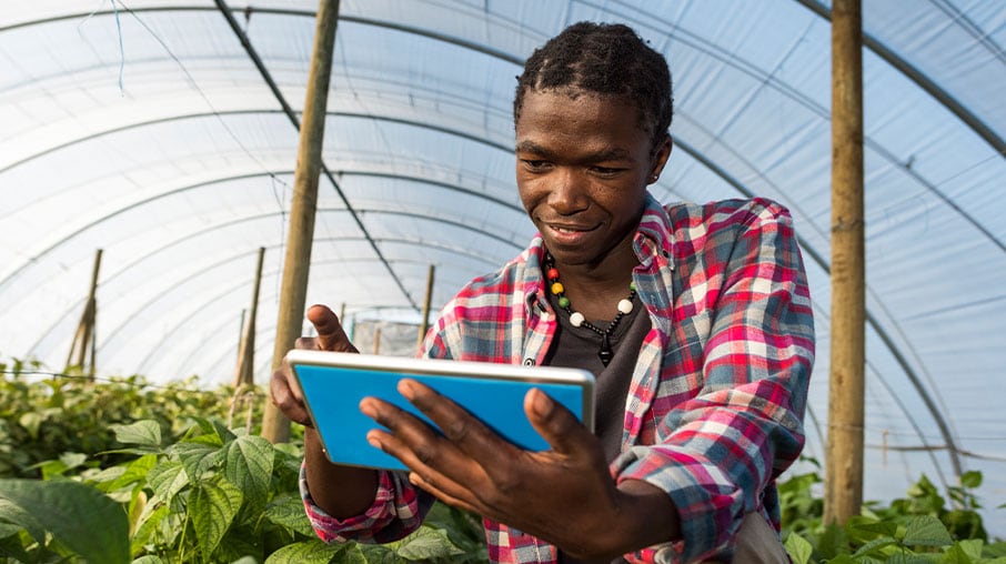 Man reading the VAT in Africa publication on his tablet.